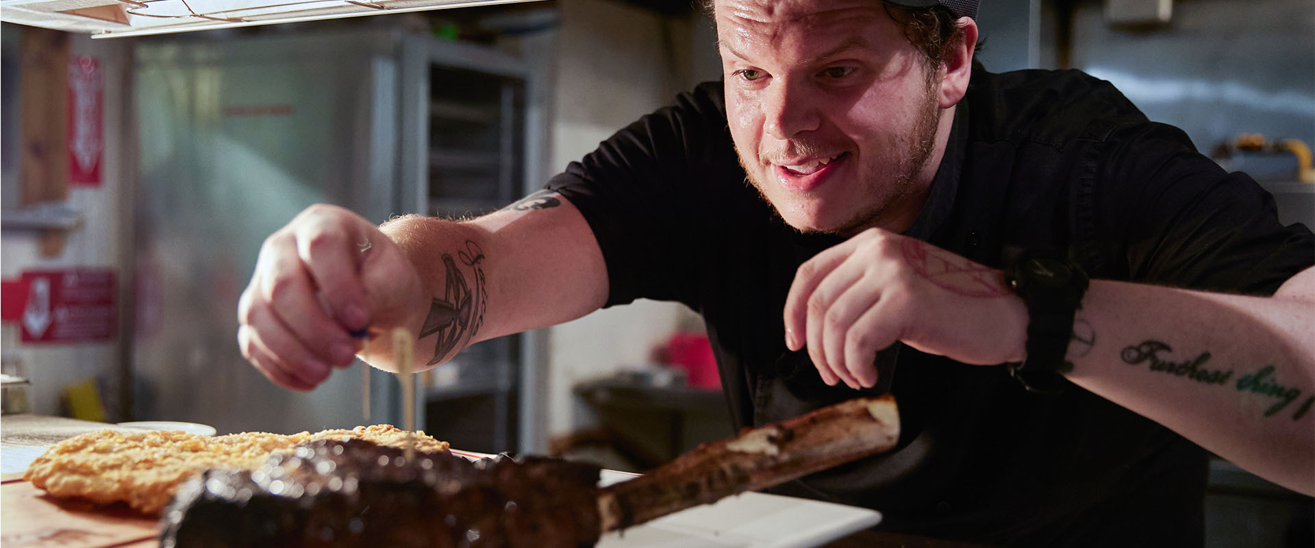 chef sticks toothpick in steak 